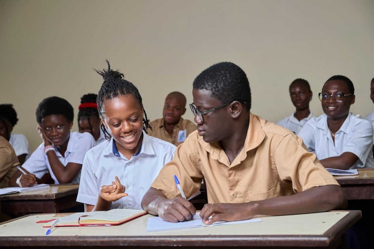 Secondary school students smiling during a lesson