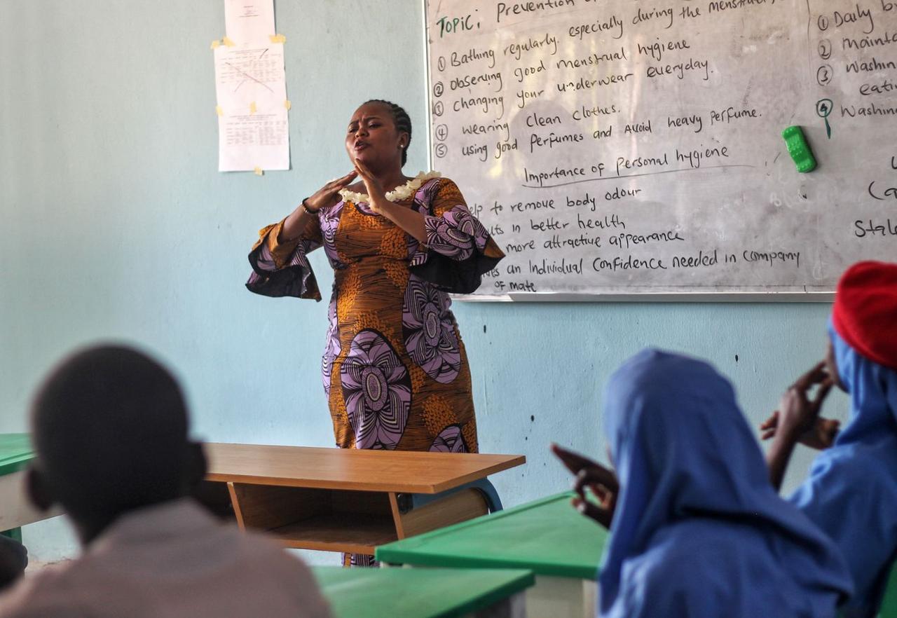 A facilitator leading a health lesson with students